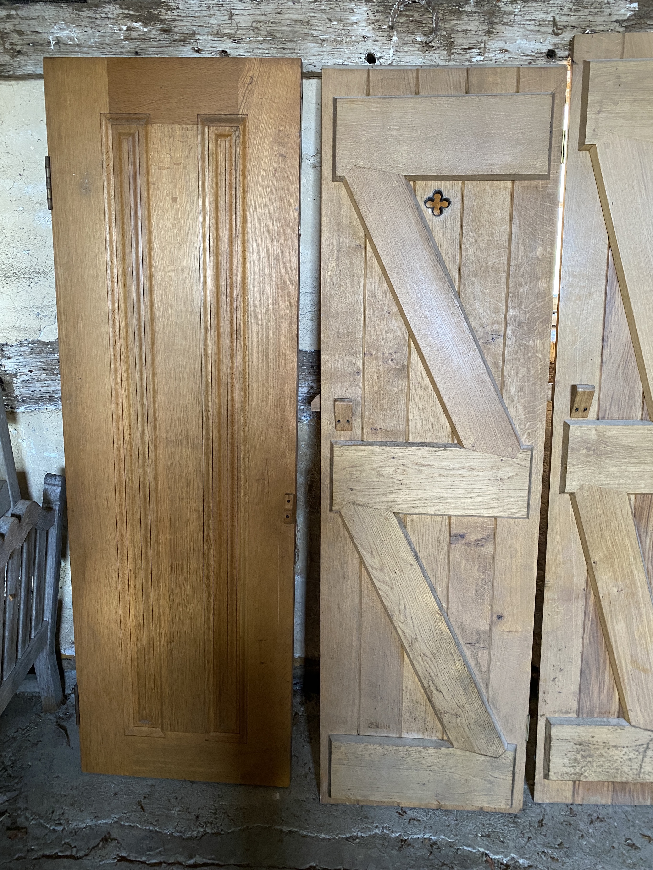 Three solid oak ledged and braced doors, 210 x 58.5cm; 204 x 44.5cm and 95 x 72cm, and a double sided panelled solid oak door, 200 x 64cm (4)